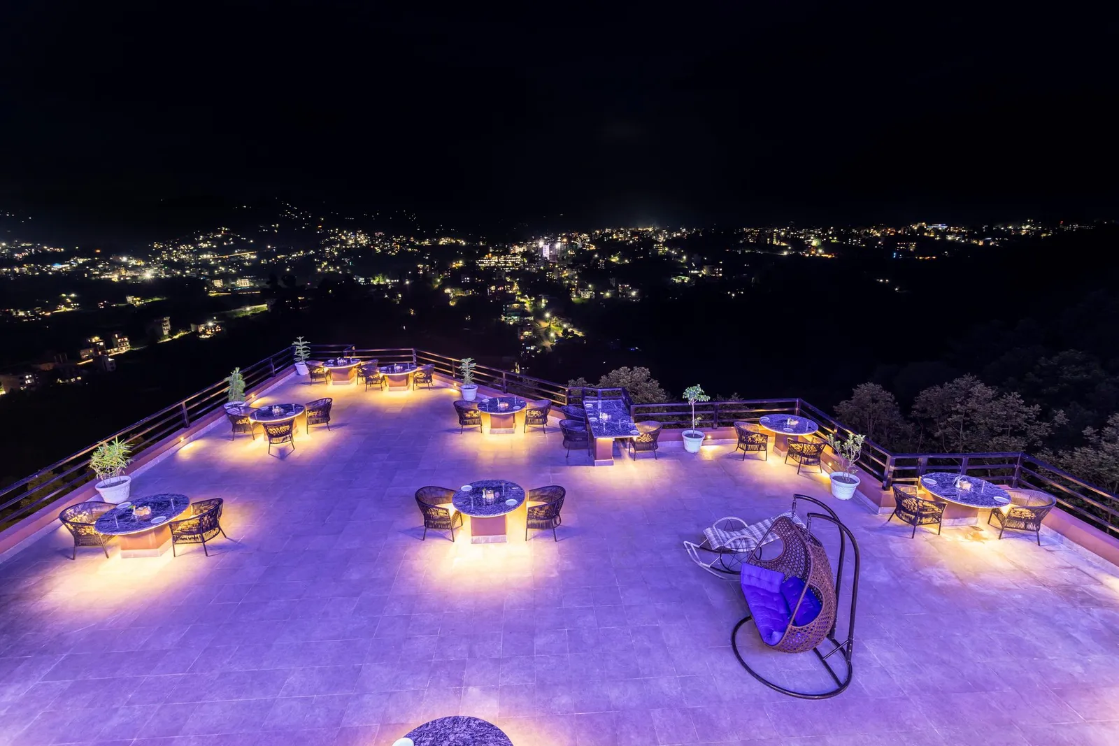 The rooftop terrace at dusk, the valley beyond